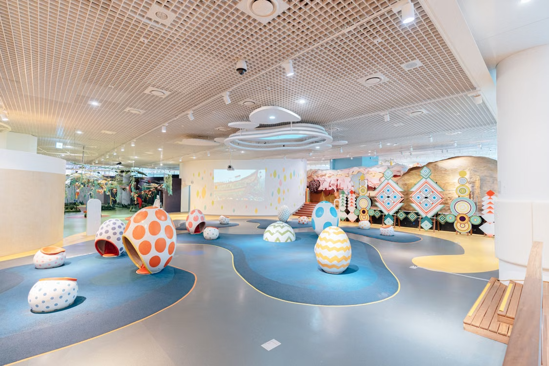 Colorful egg-shaped play pods on an indoor playground floor